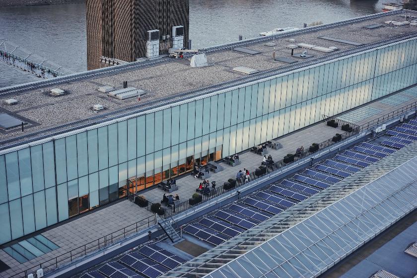 an aerial view of a building next to a body of water